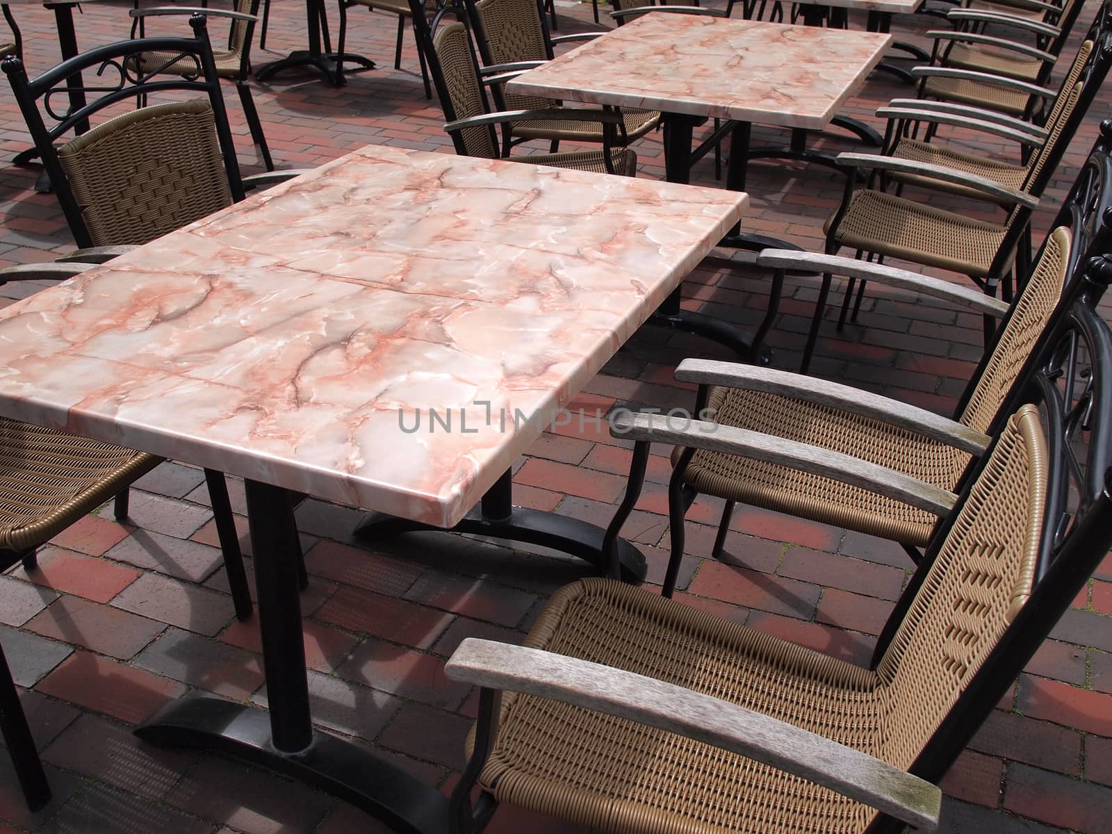 Classic style European street outdoors cafe restaurant with tables and chairs 