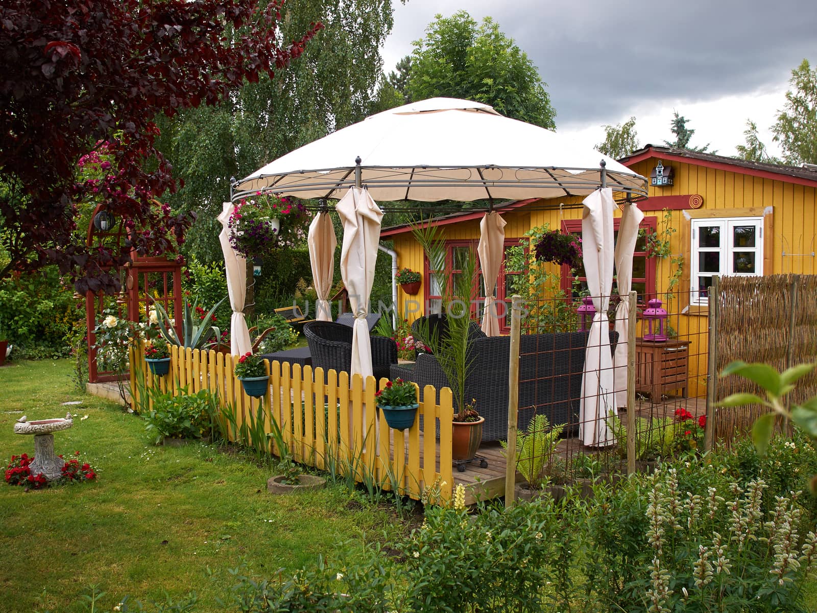 Beautiful Idyllic Wooden Summer house in a blooming garden