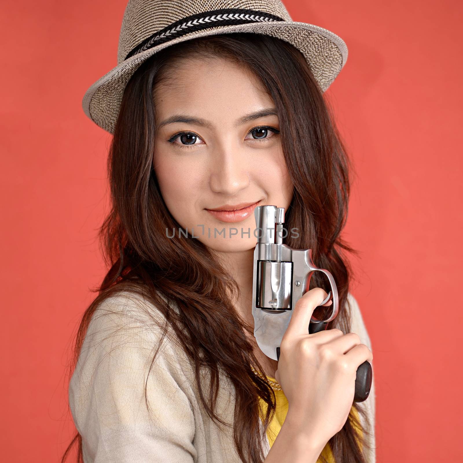 Young asian cute woman with handgun revolver