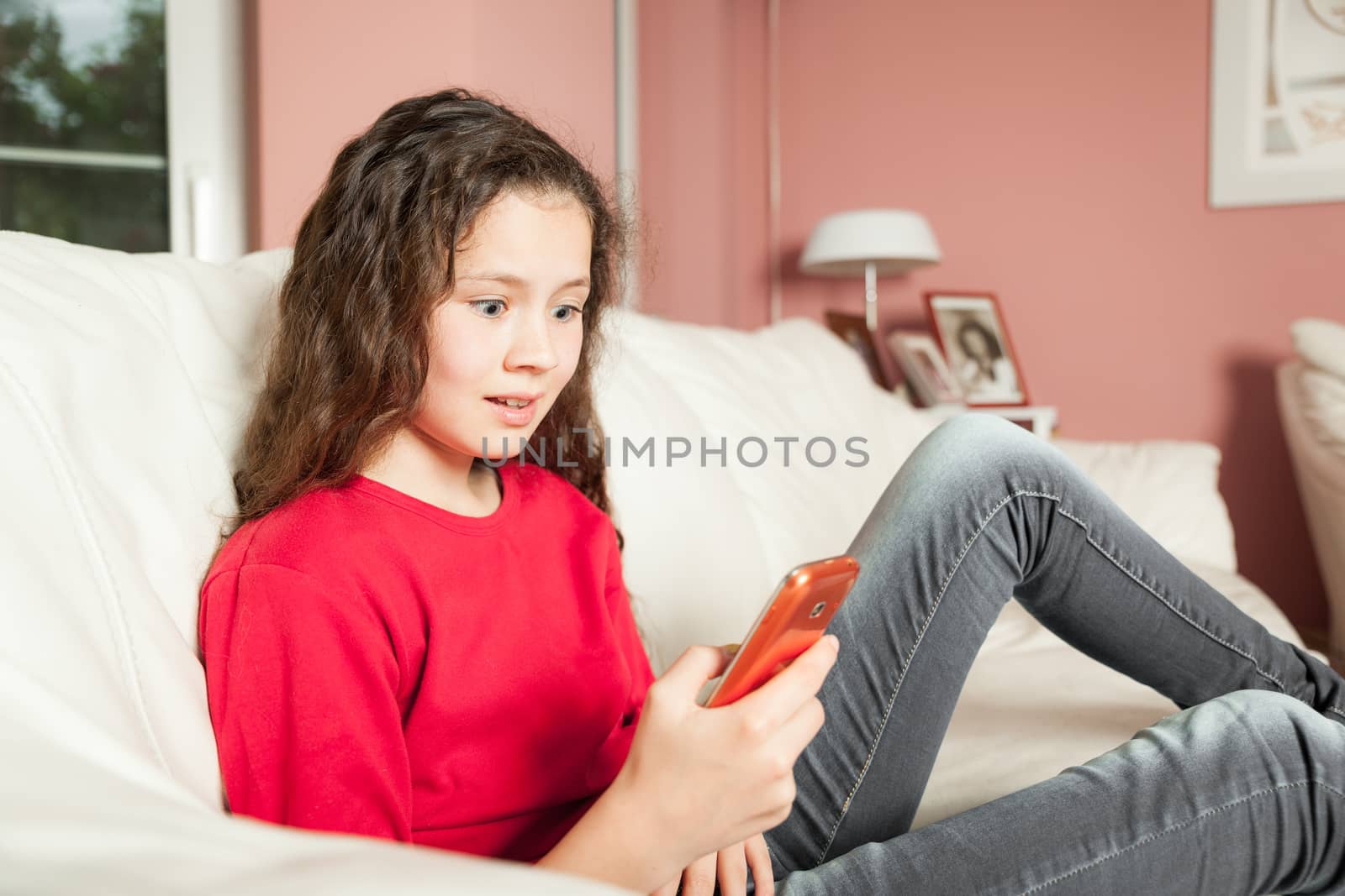 An image of a young girl with a mobile phone