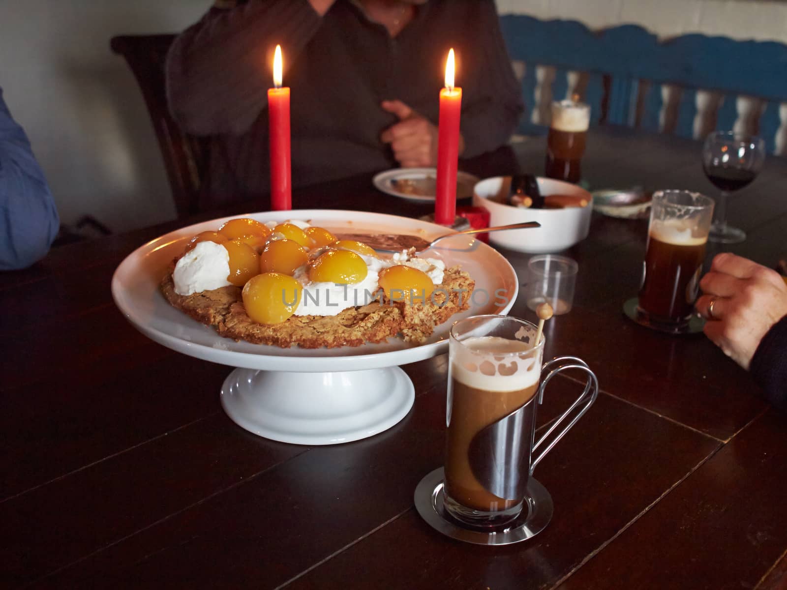 Irish coffee and delicious cake in a cozy candle light atmosphere