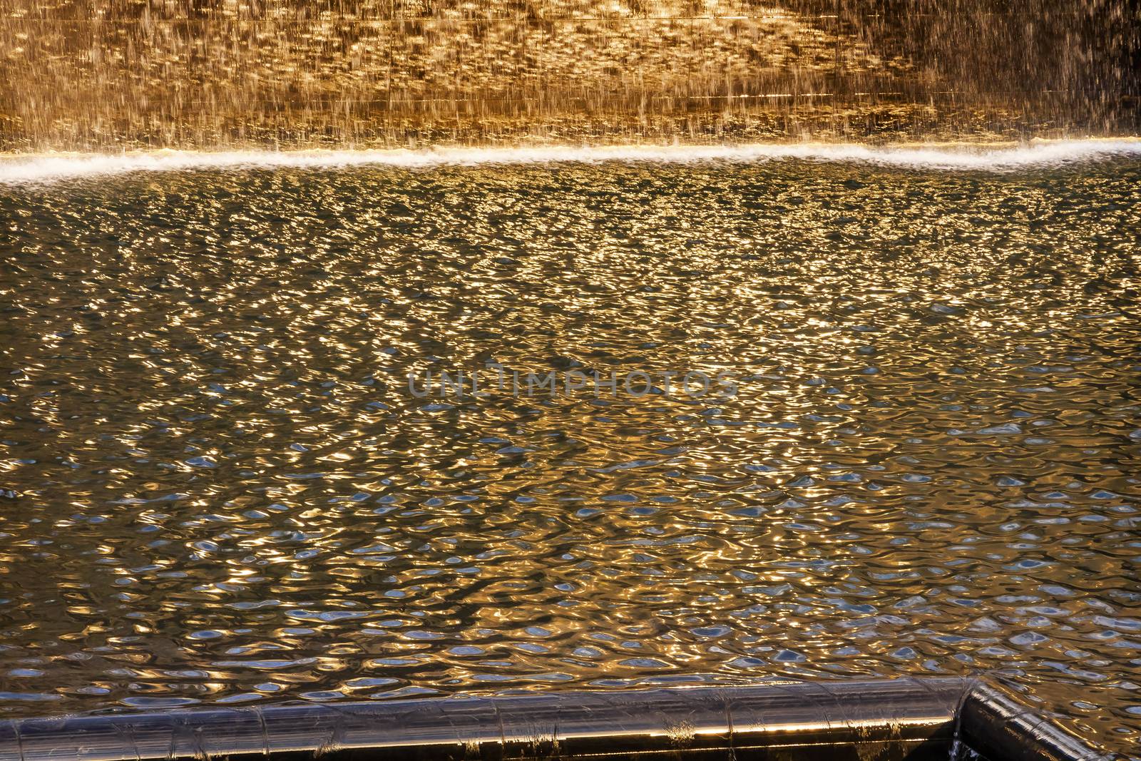 911 Memorial Pool Fountain Waterfall Reflections Abstract New York NY.  Pool is in the foundation of one of the Two World Trade Center Buildings.  Water falls into hole of the foundation.  