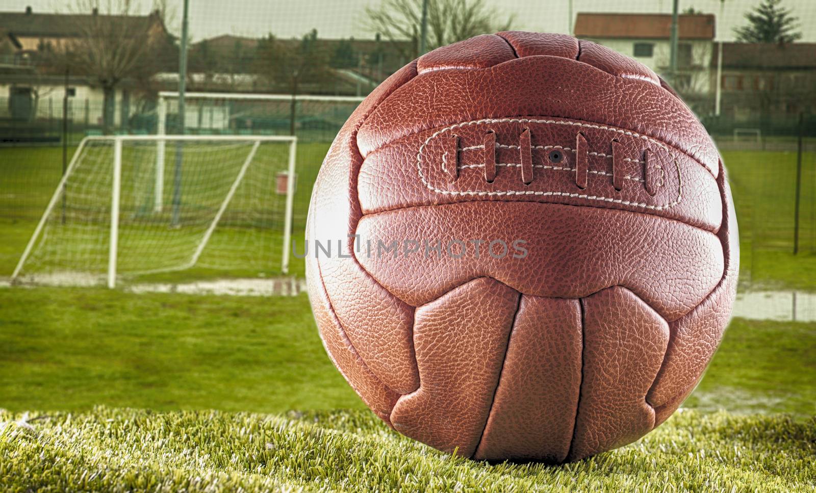 Old vintage football over a small football field