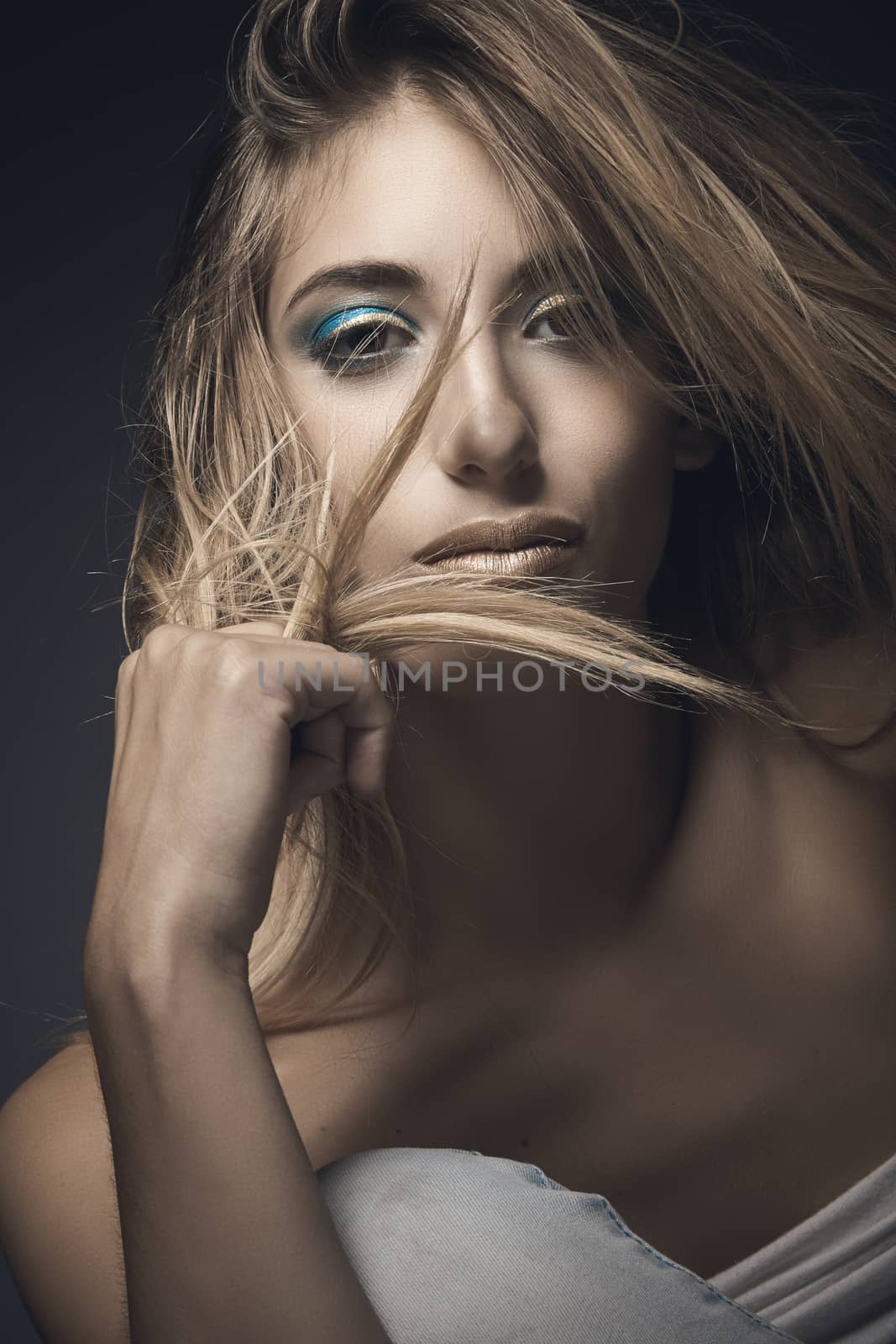 Beauty portrait of sexy blonde woman against grey background