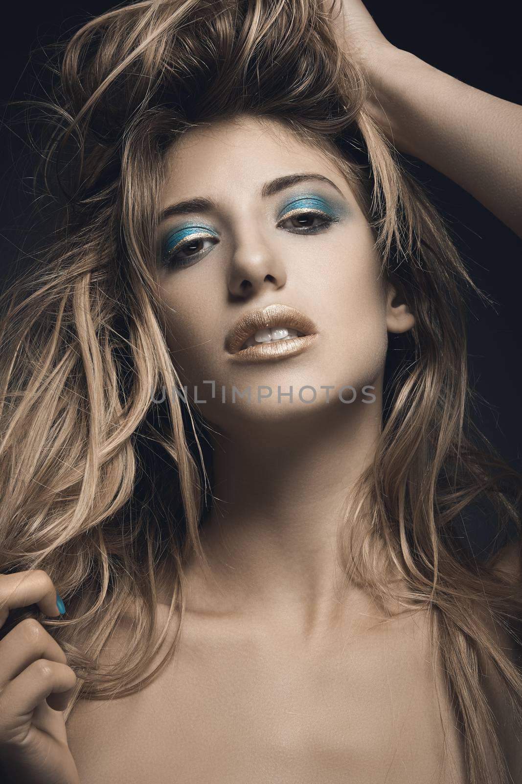 Beauty portrait of young sexy woman against blue background