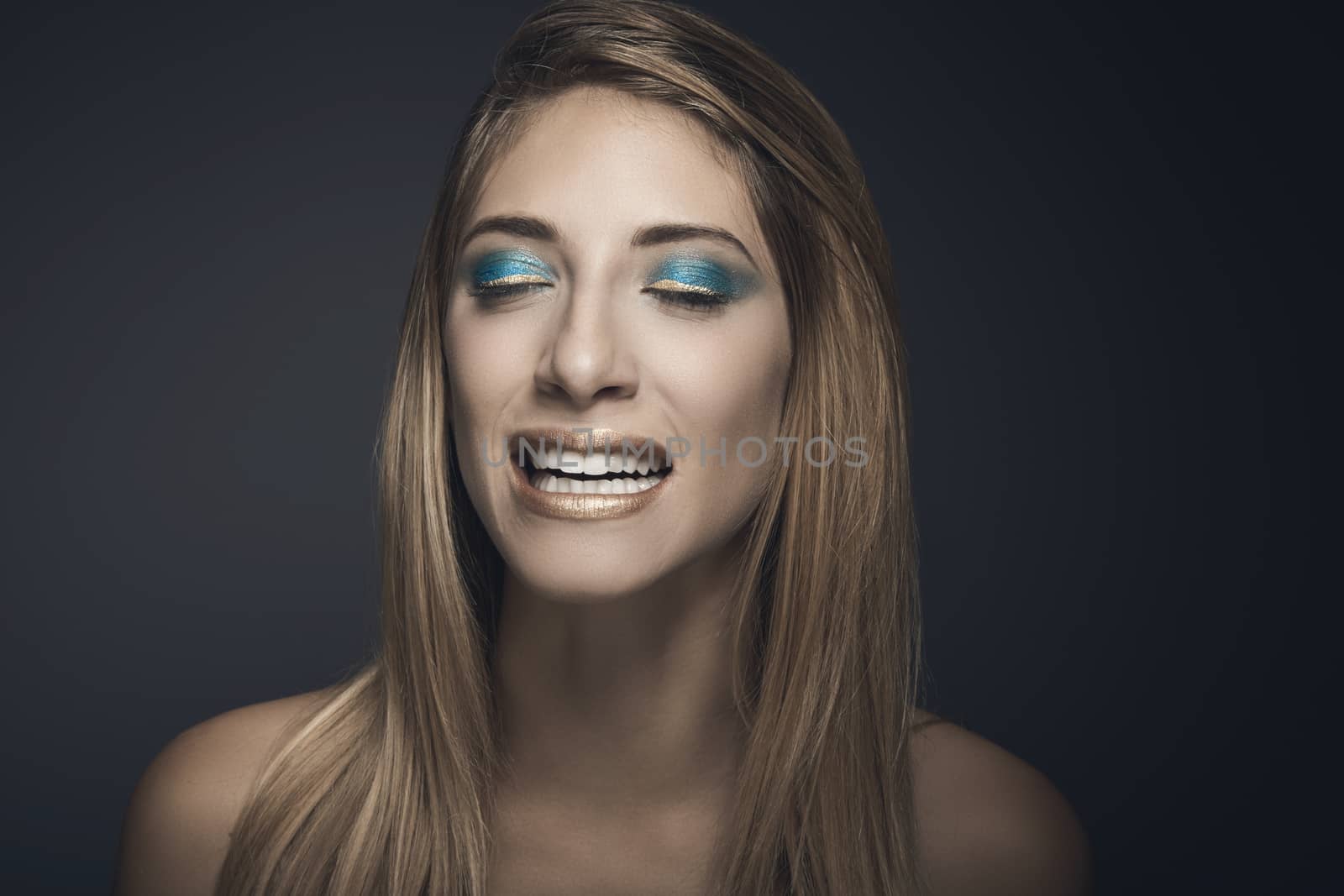 Beauty portrait of young sexy woman against blue background