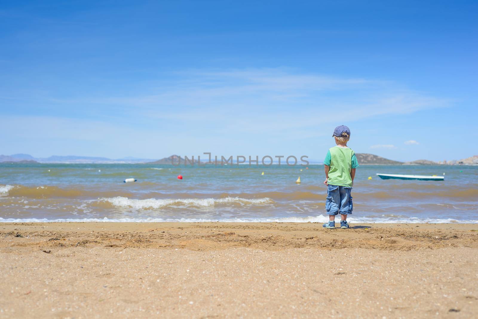 Little boy standing on the beach by anytka