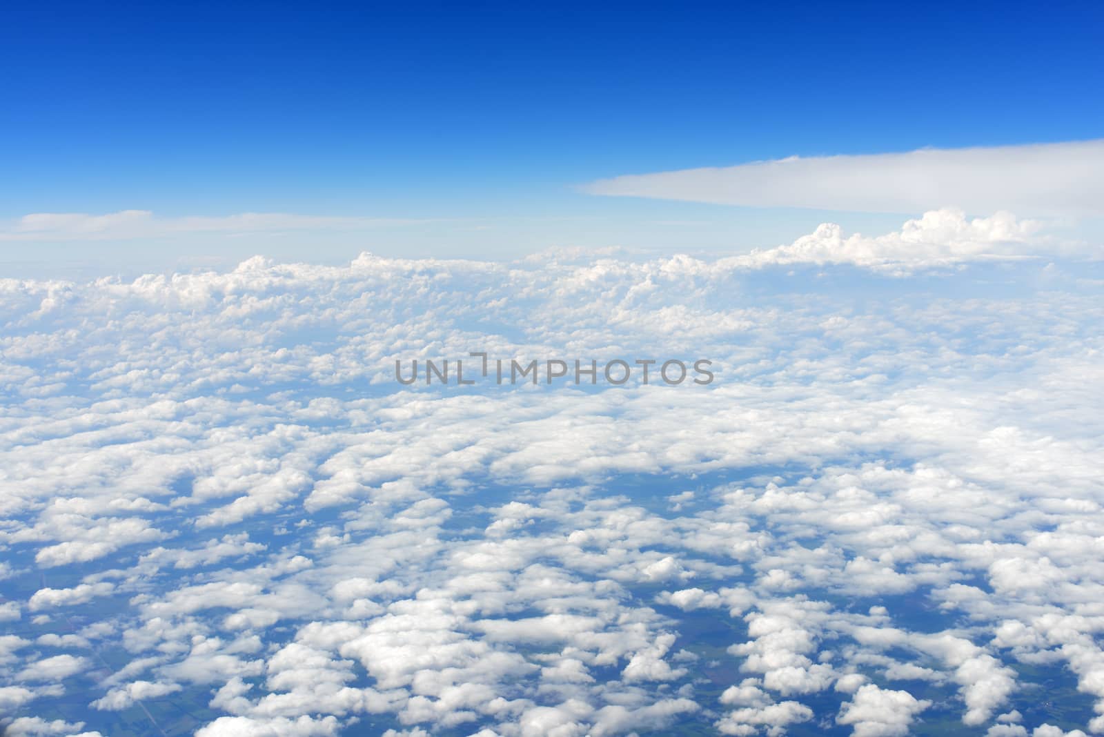 Blue sky and clouds. Top view of aircraft