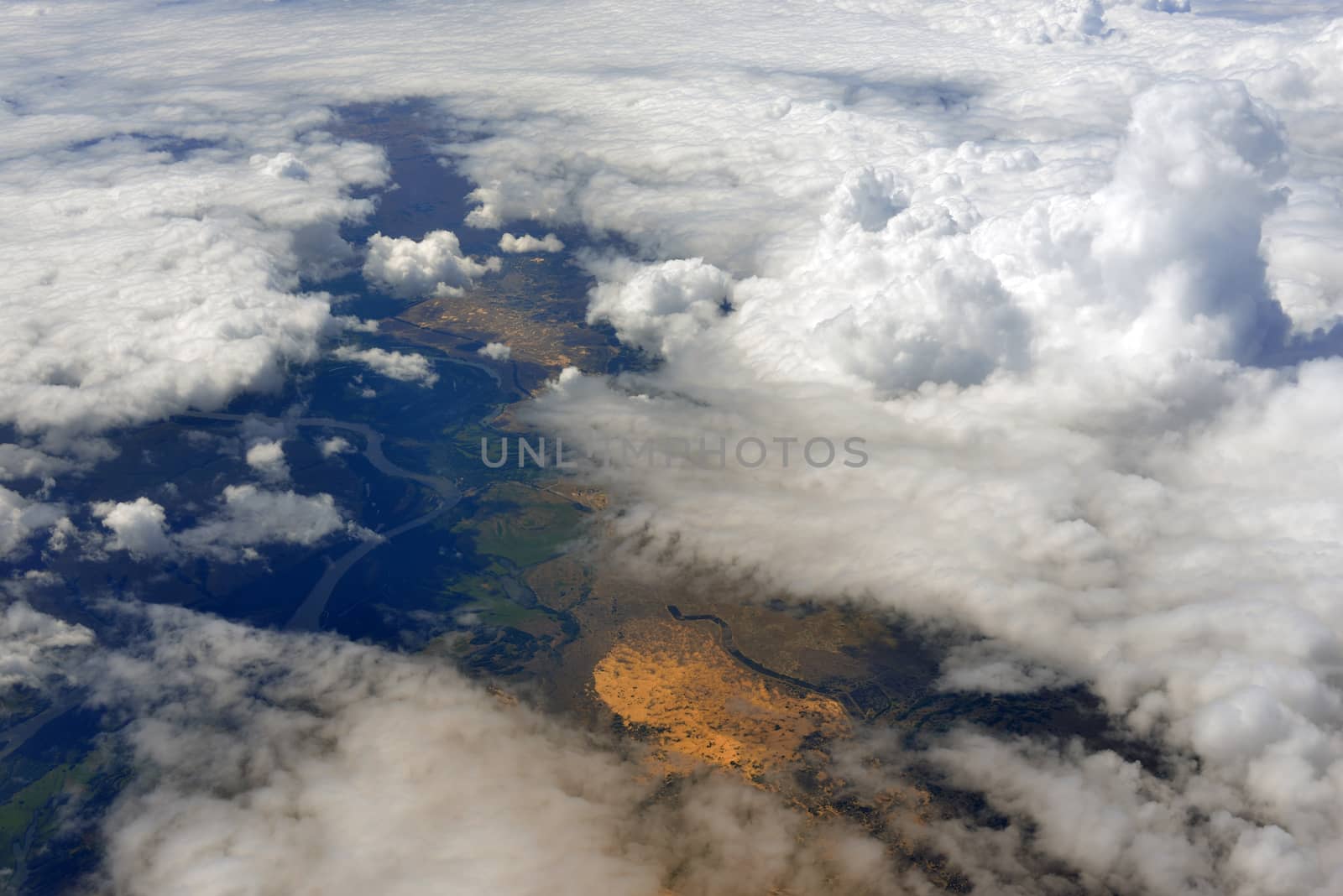 Earth's surface and clouds. Top view of aircraft