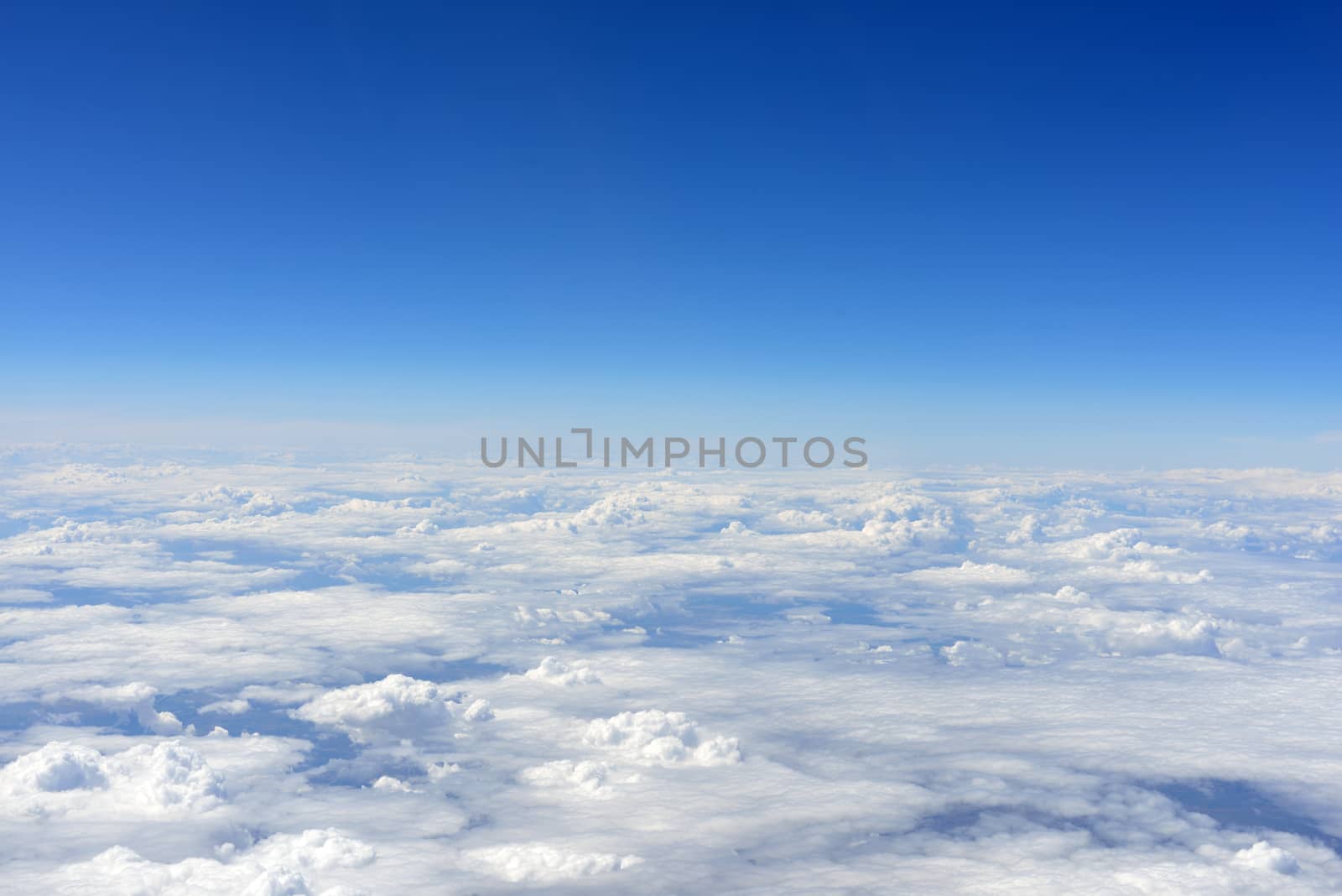 Blue sky and clouds. Top view of aircraft