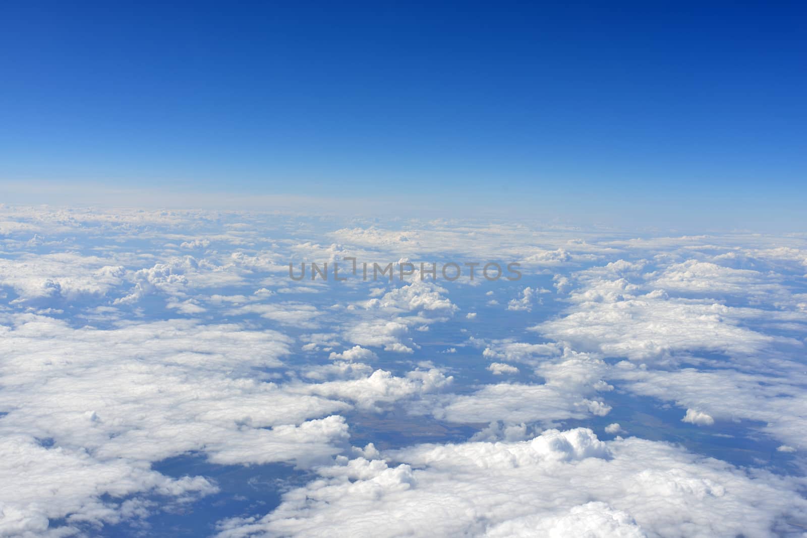 Blue sky and clouds. Top view of aircraft