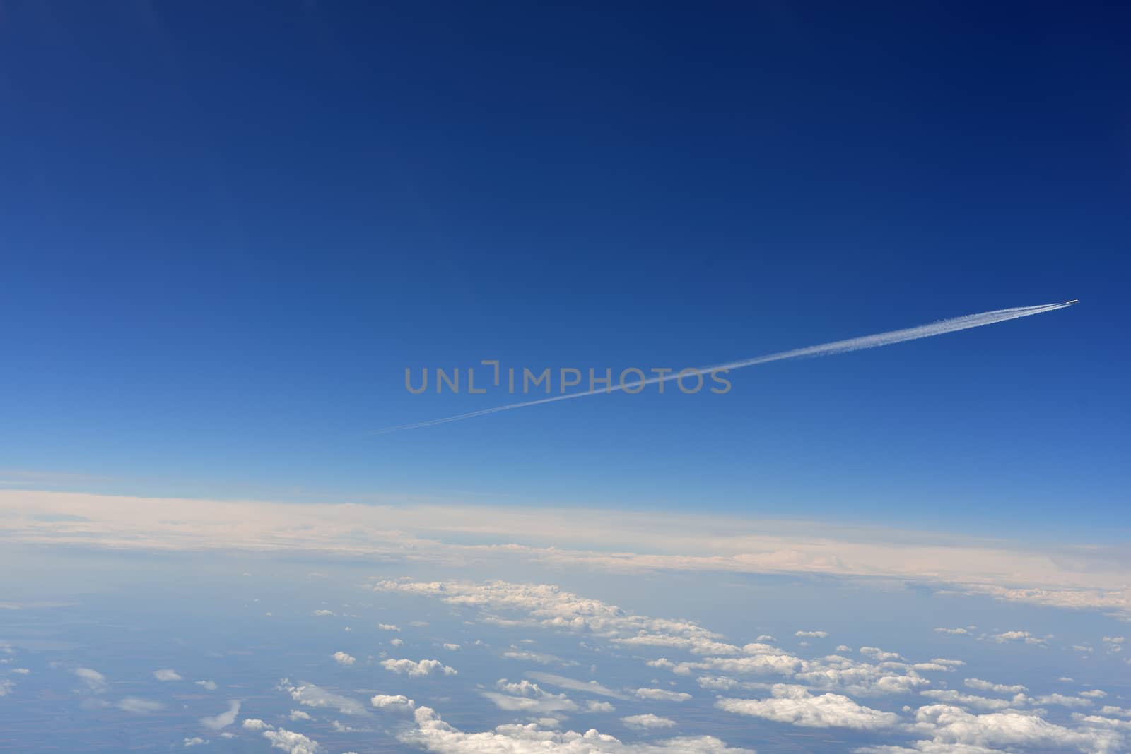 Blue sky and clouds. Top view of aircraft