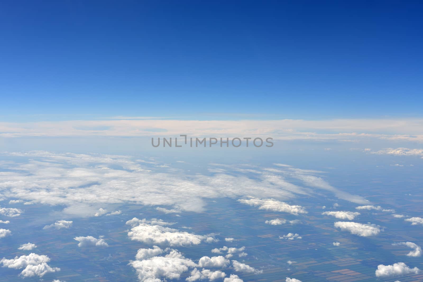 Earth's surface and clouds. Top view of aircraft