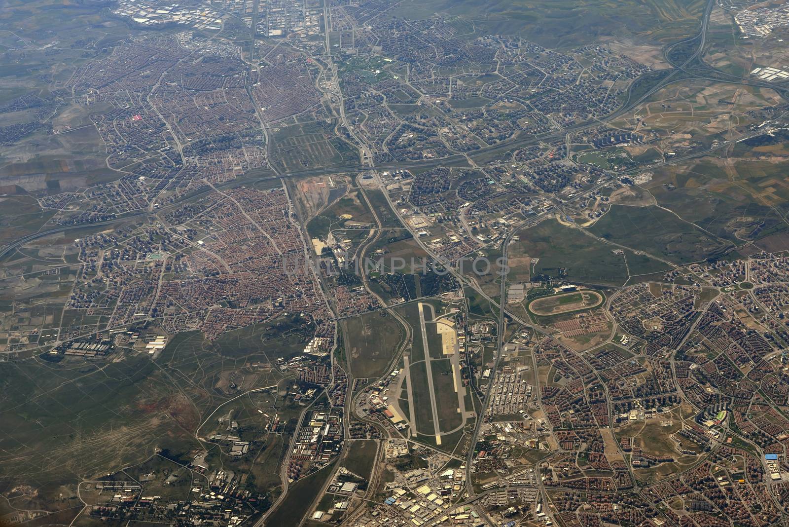 Aerial view of the city. Buildings, fields, trees and roads