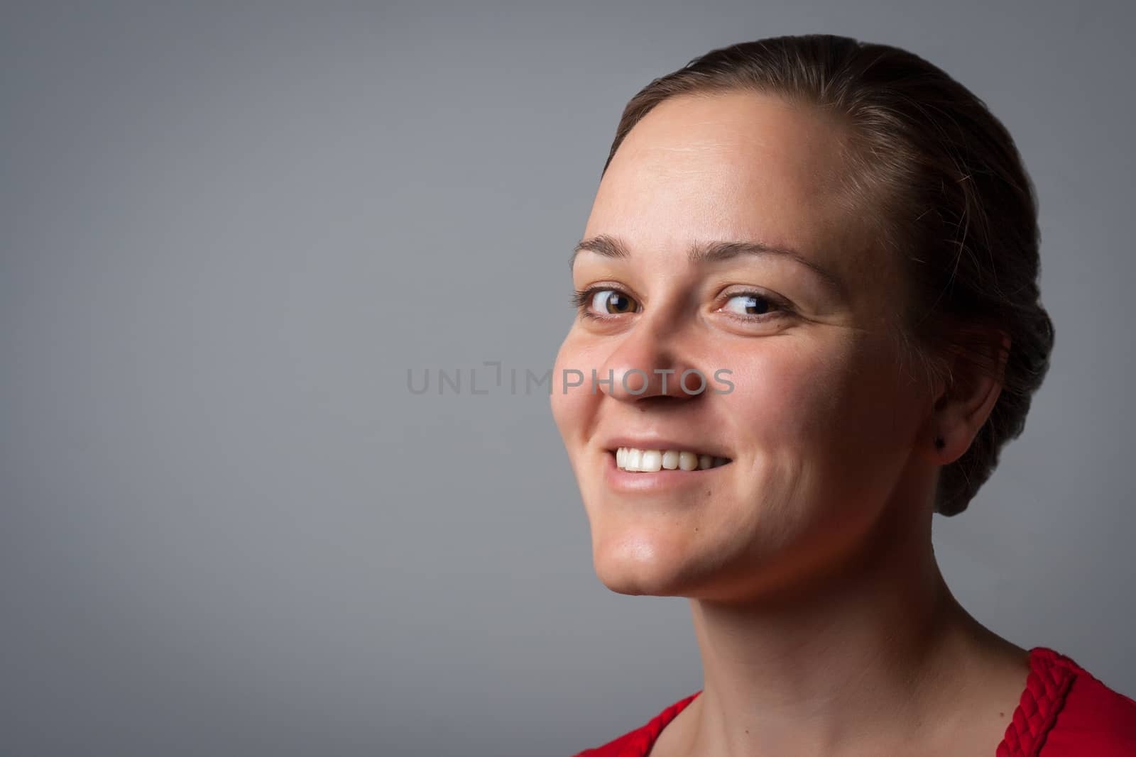 portrait of a smiling woman on grey background