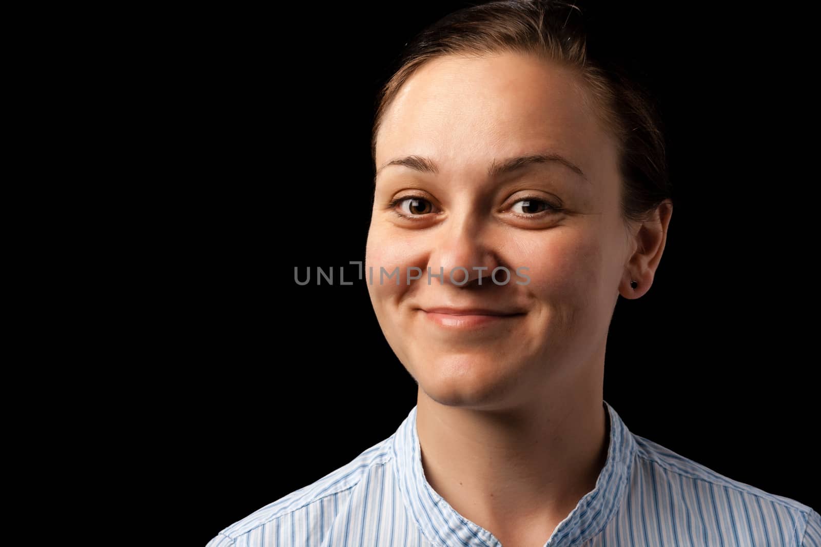 portrait of a smiling woman on dark background