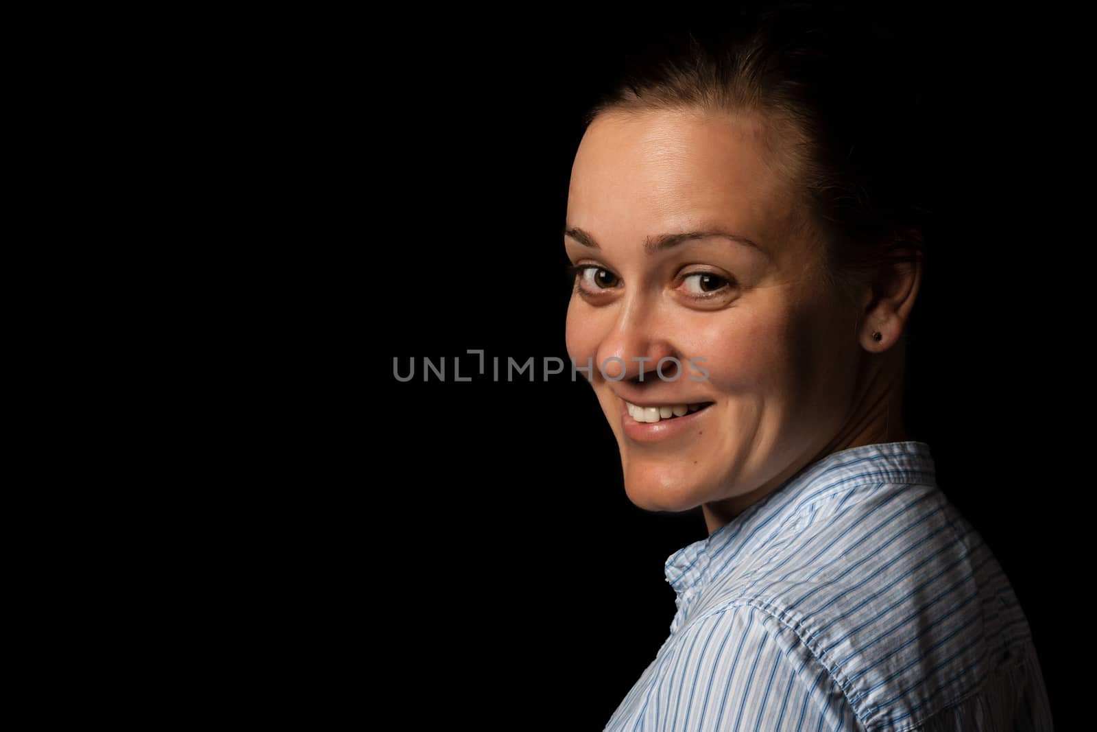 portrait of a smiling woman on dark background
