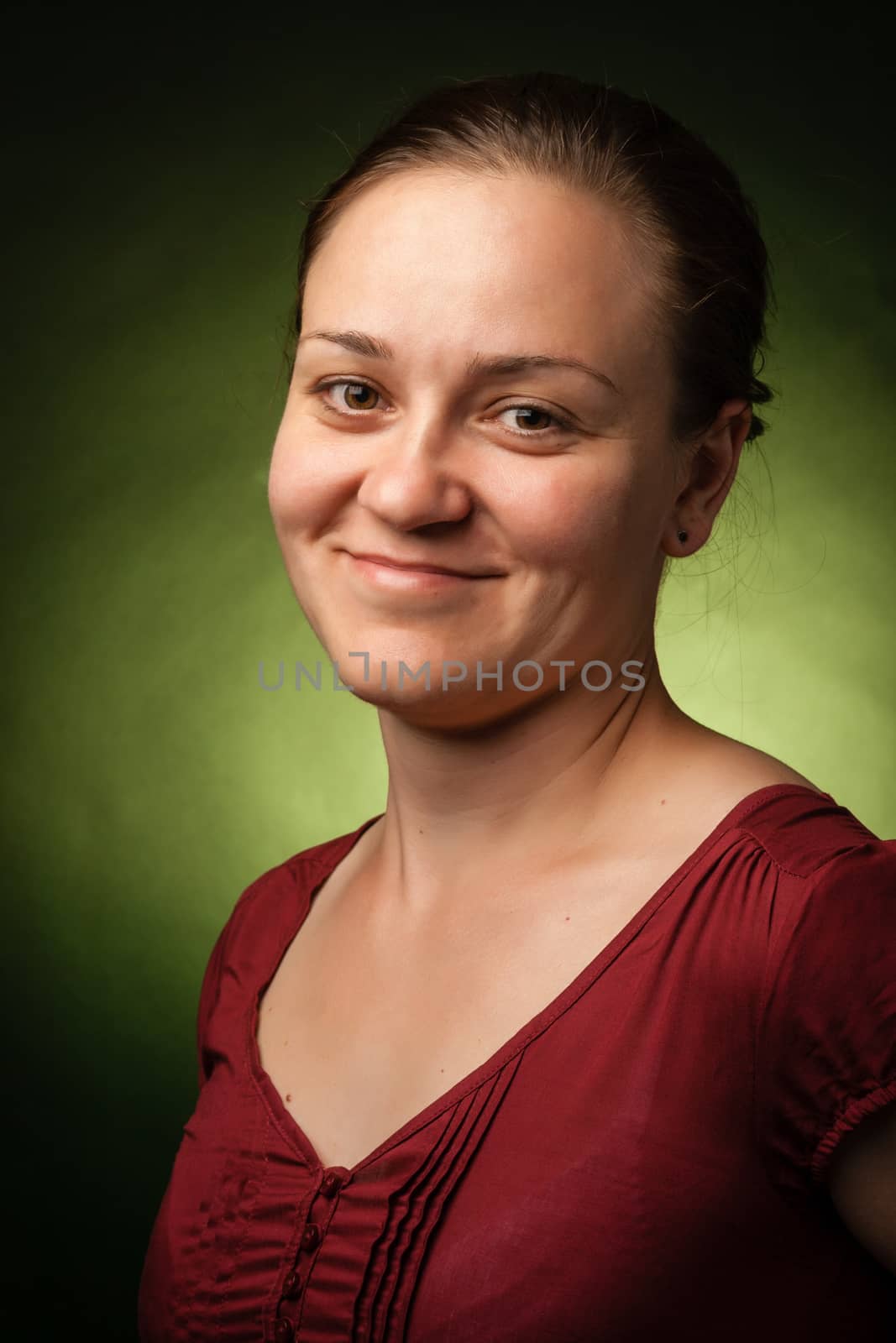 portrait of a smiling woman with green back light