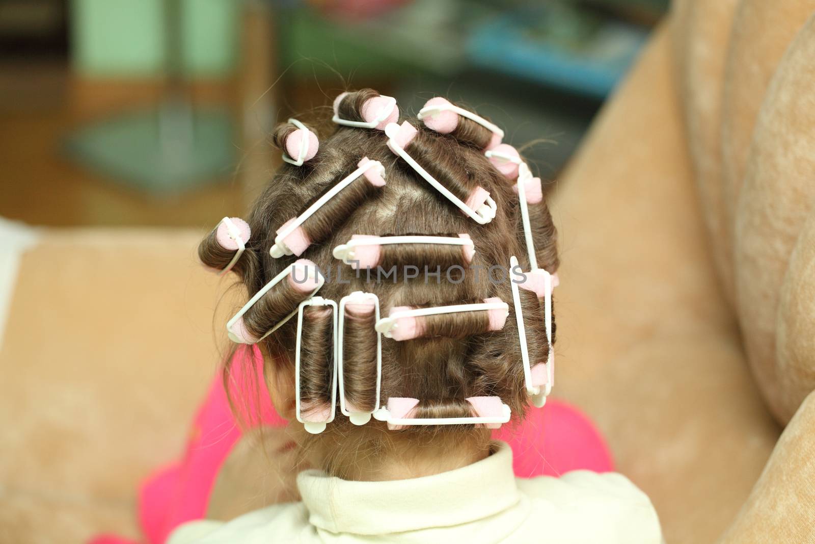 little girl in hair curlers