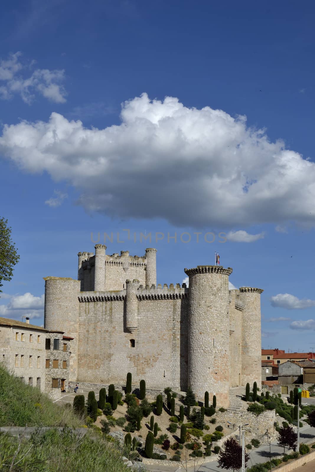 Torija castle under a cloud, blue sky, Spain