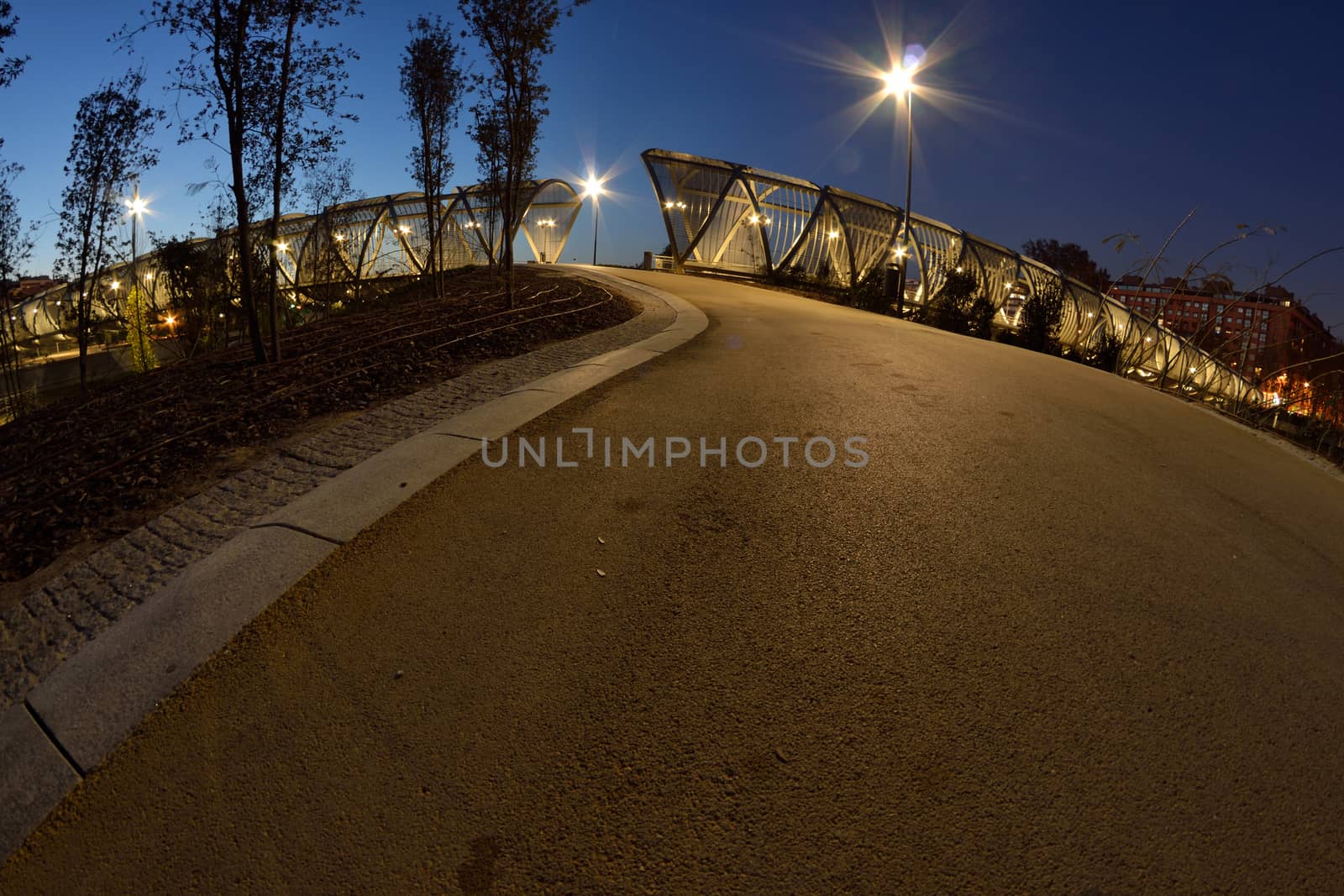 Footbridge in the Madrid Rio park, at night, with a fisheye lens, Madrid, Spain