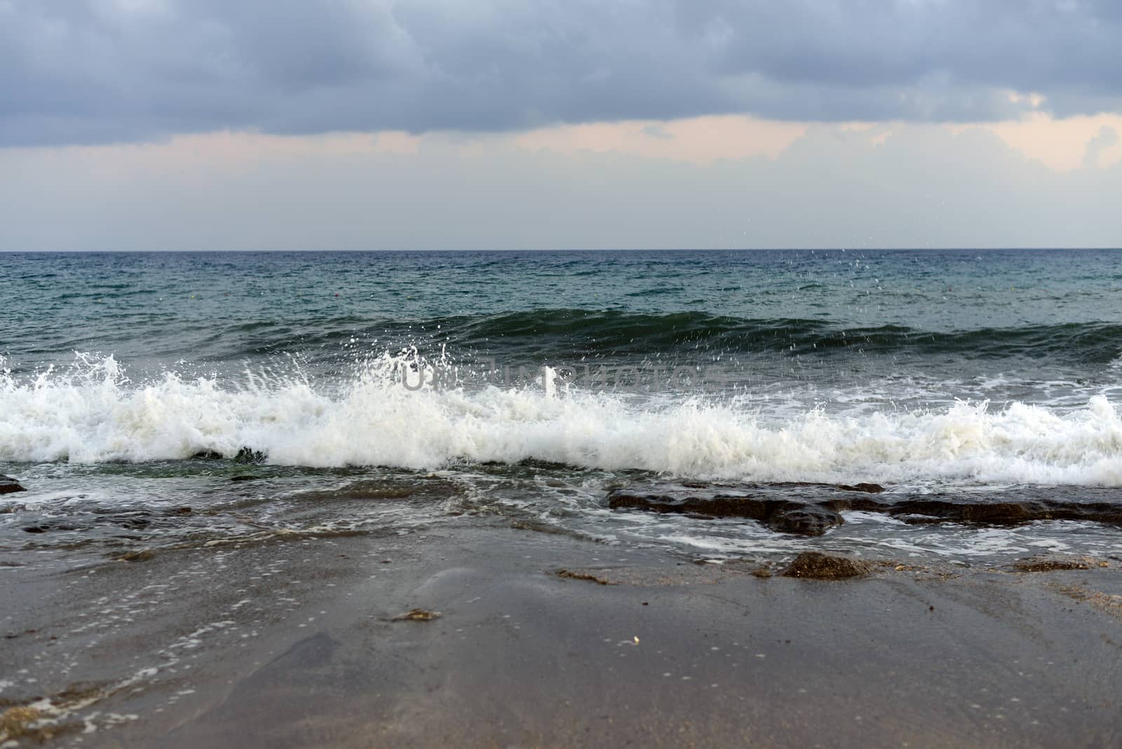 Sea wave rolled ashore. Blue sky in the background