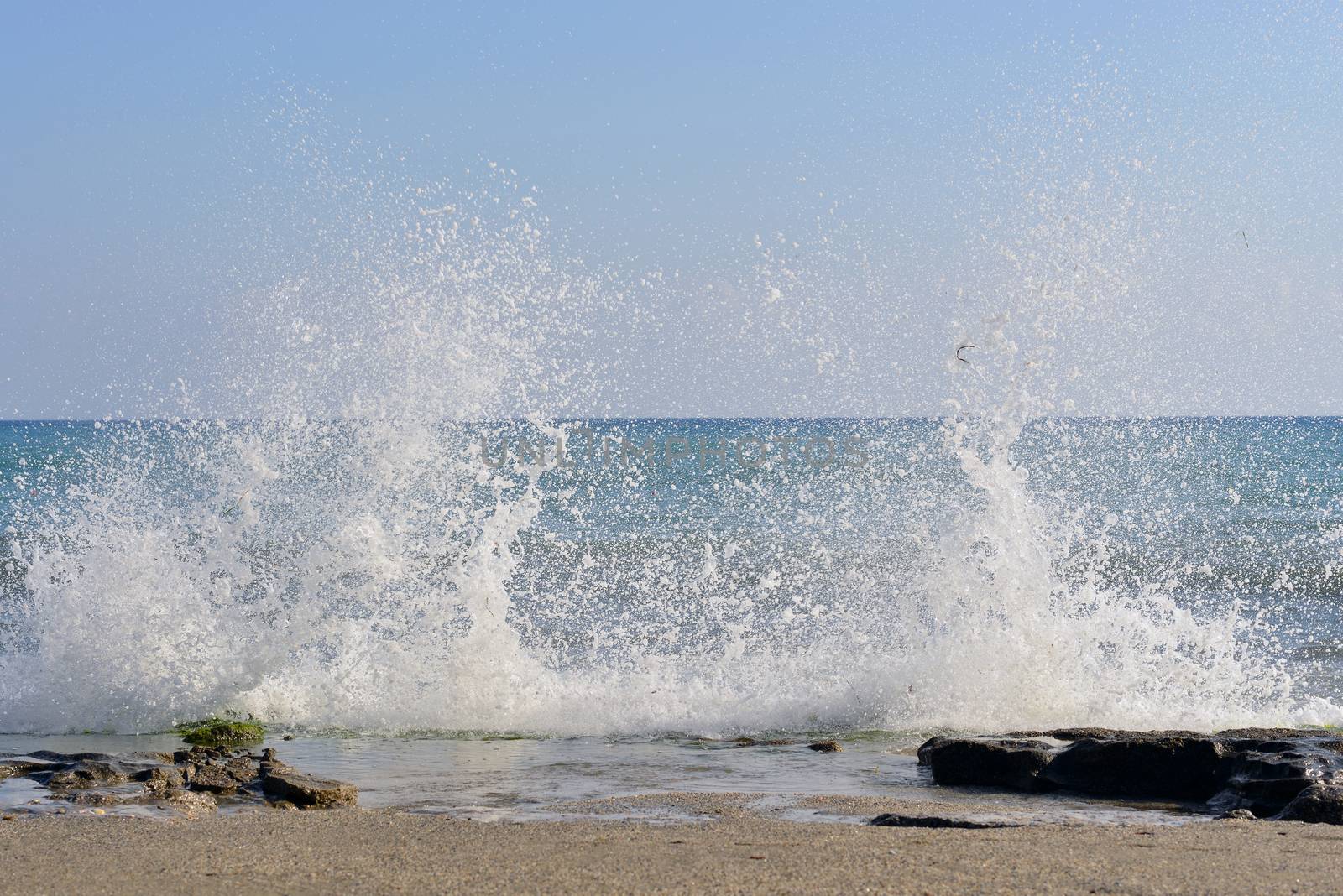 The waves breaking on a stony beach by cherezoff