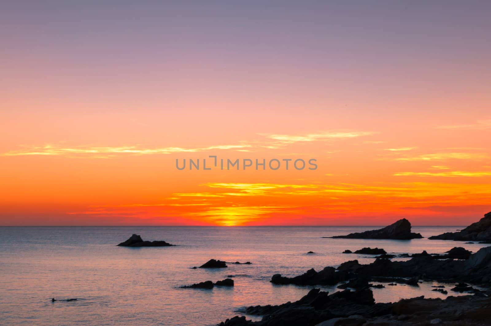 Beautiful sunset on the Sardinian coast orange and purple