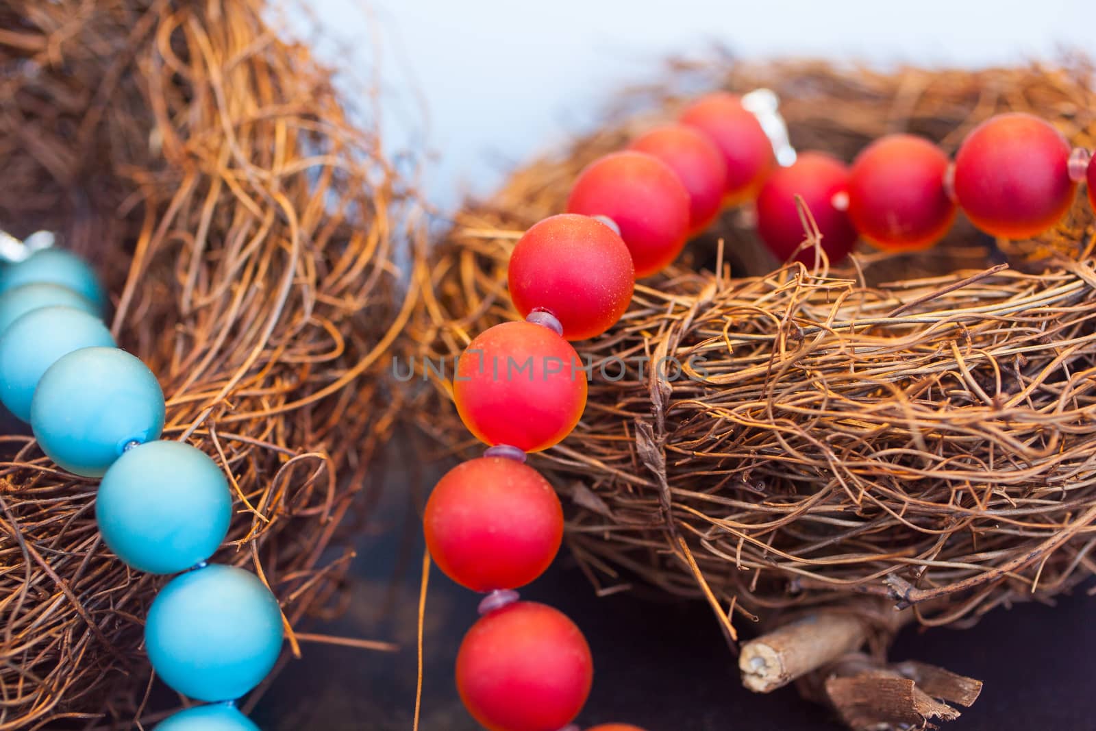 Close up of red pearls necklace on nest