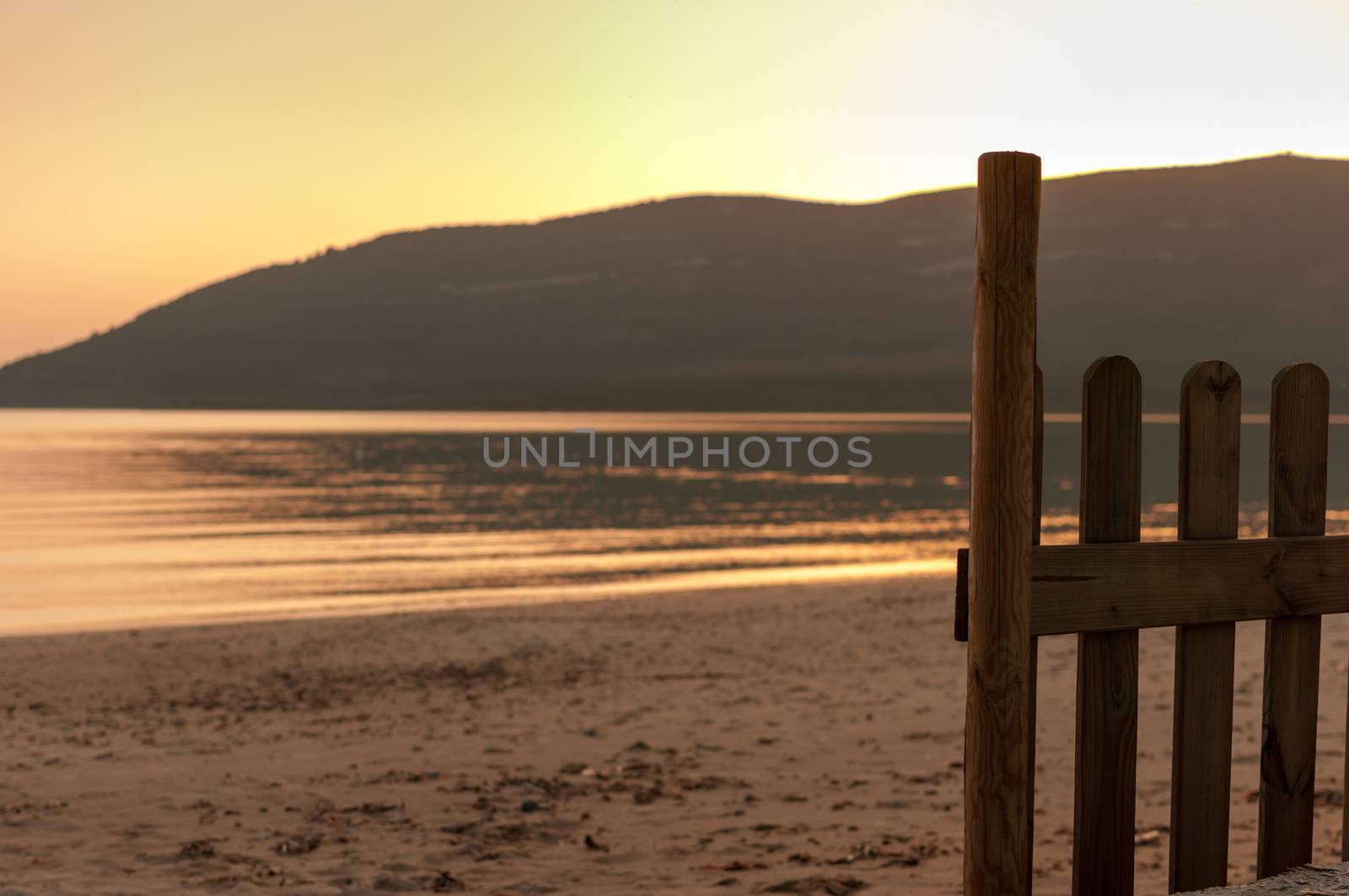 little fence on the beach in a spring sunset