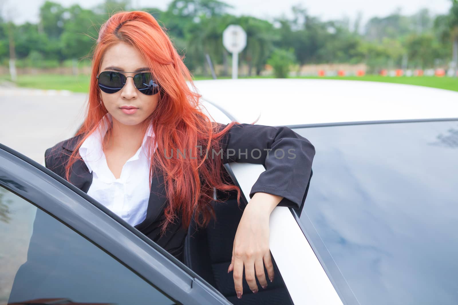 Young asian business woman with car