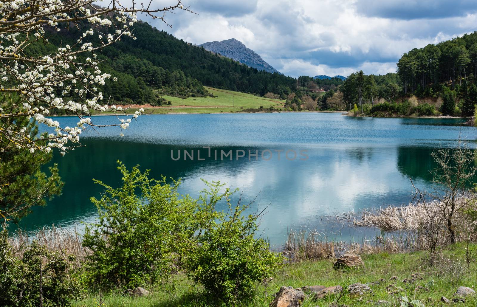 A blue lake under a cloudy sky - landscape.