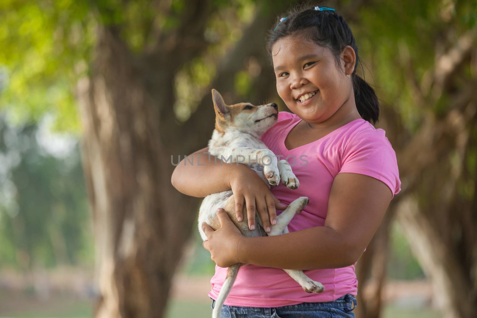 little asian girls and puppy in the garden