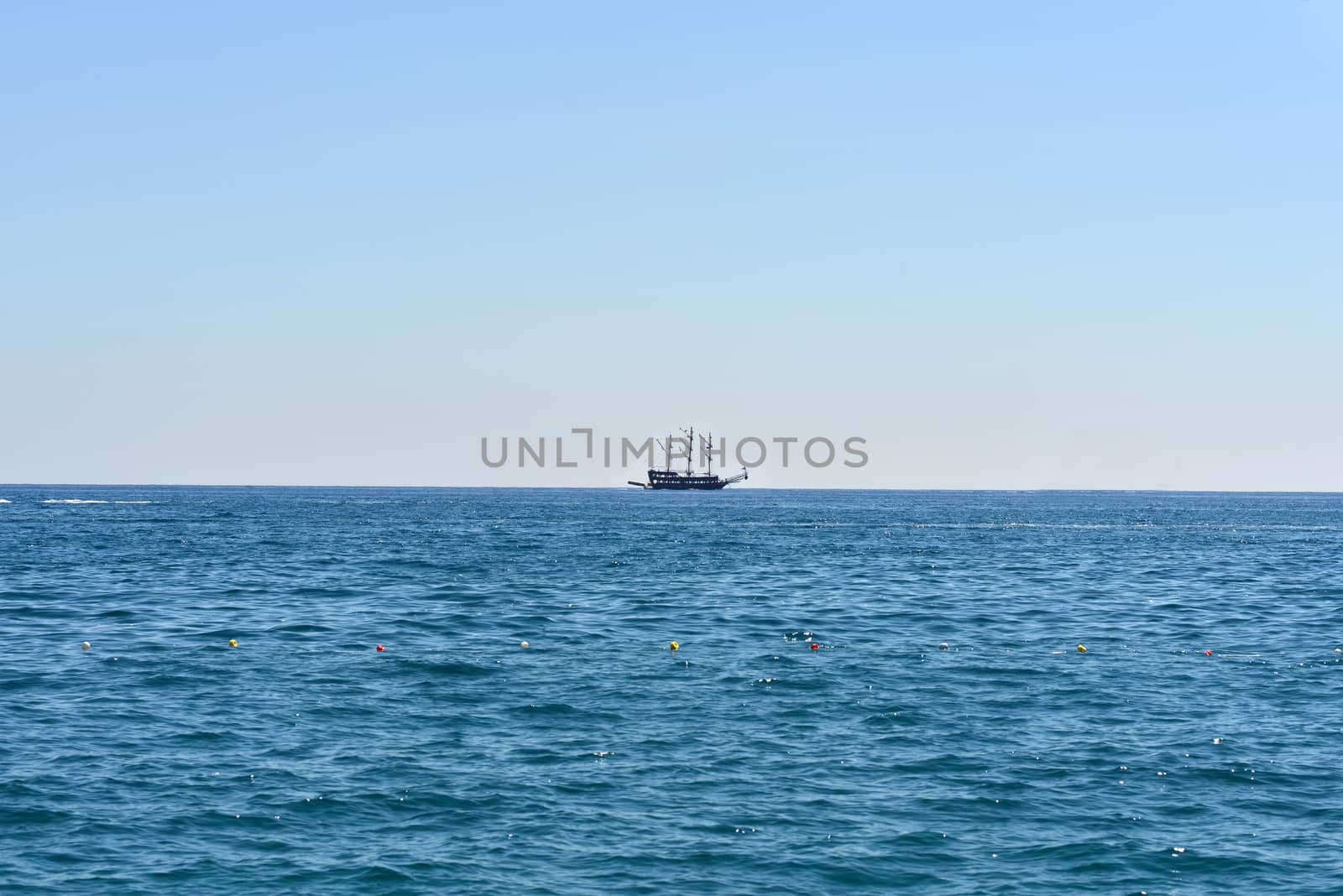 Old marine vessel in the sea. Blue sky on background