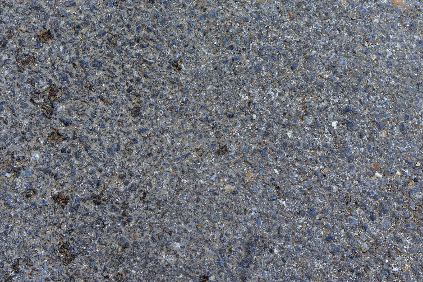 Dark asphalt surface much relief. Close up
