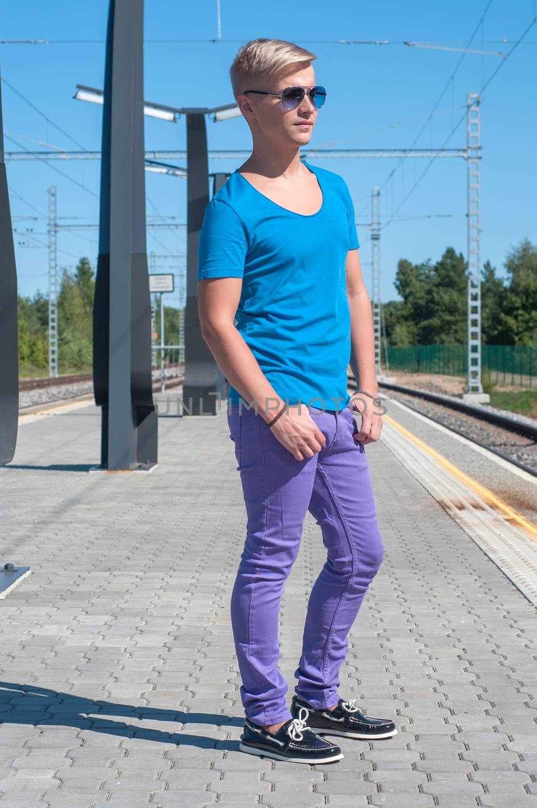 Stylish man  in blue standing on train station by anytka