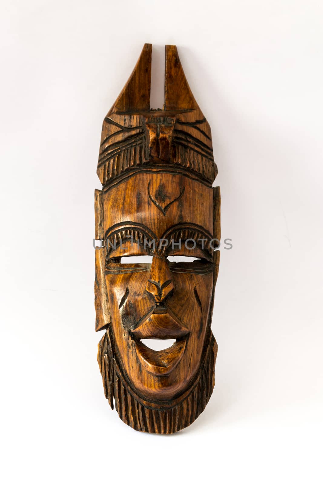 Wooden african mask on a white paper