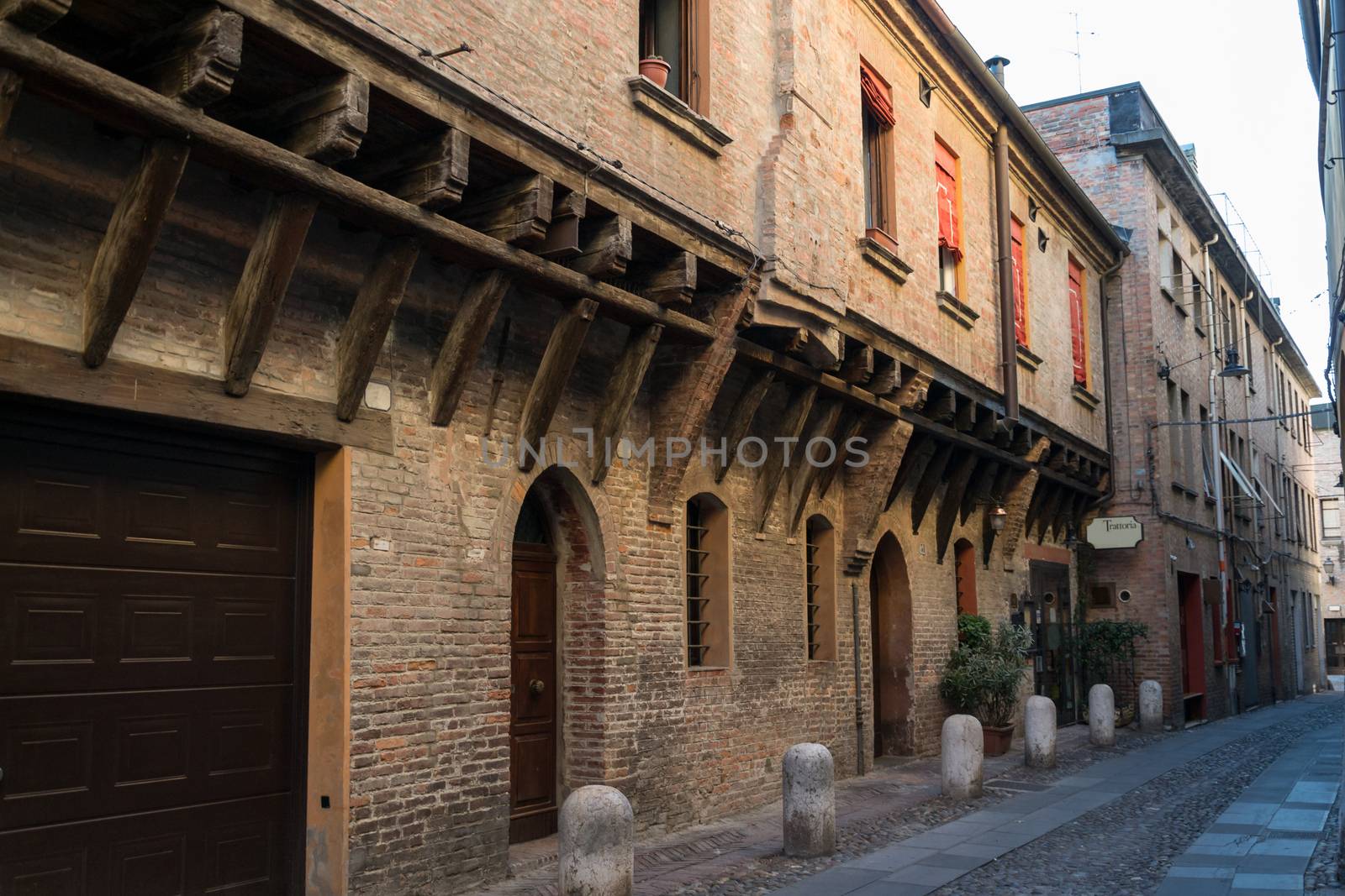 Medieval street in Ferrara with a Trattoria