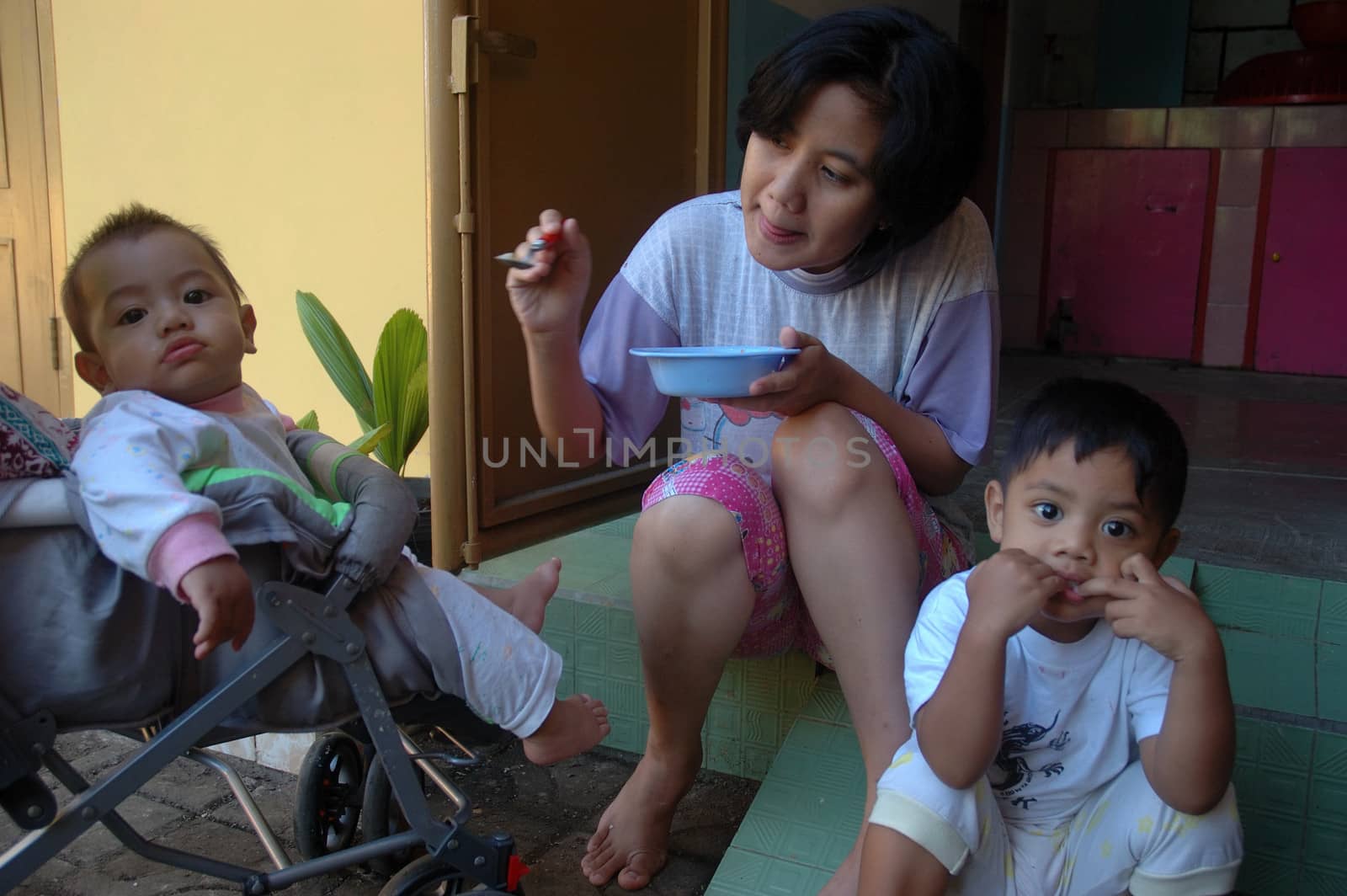 bandung, indonesia-december 19, 2010: family portrait that shown interaction between mother and kids.