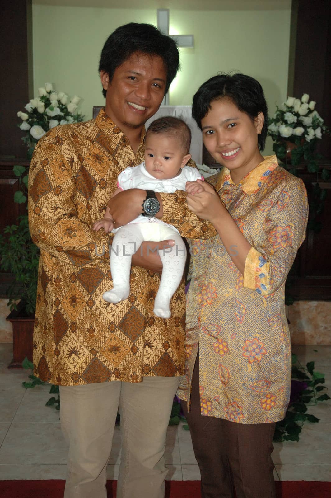 bandung, indonesia-december 19, 2010: family portrait after baptism ceremonial.