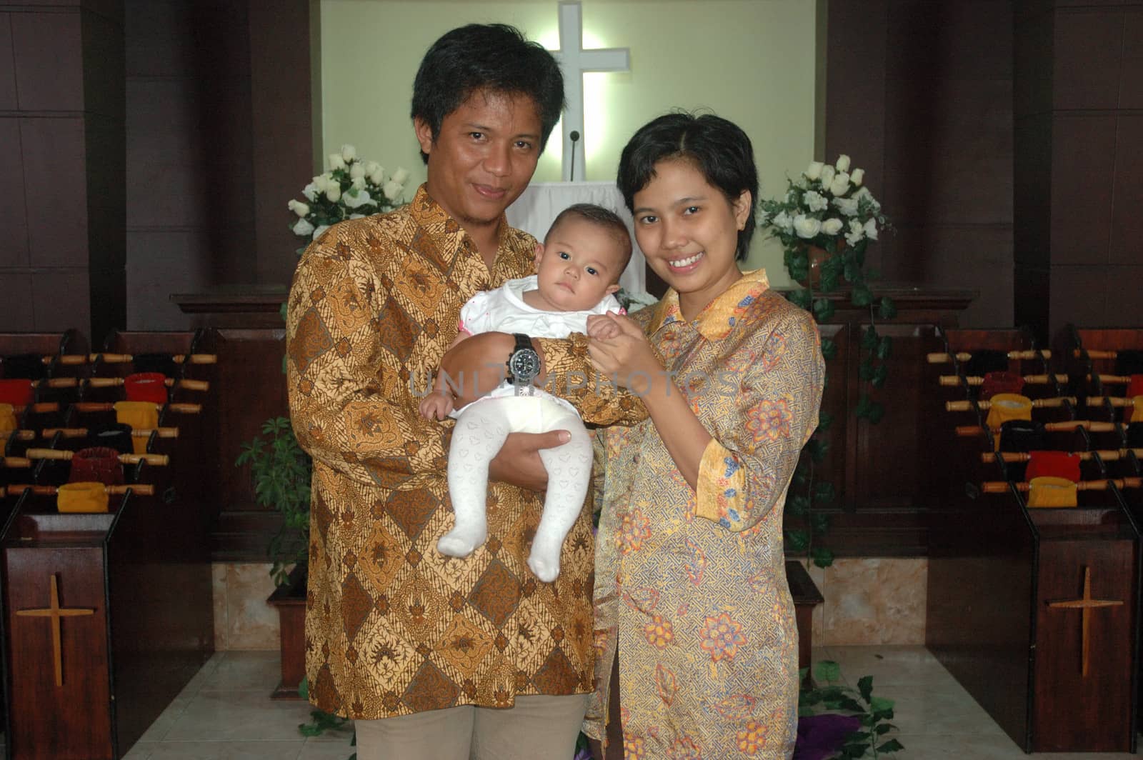 bandung, indonesia-december 19, 2010: family portrait after baptism ceremonial.