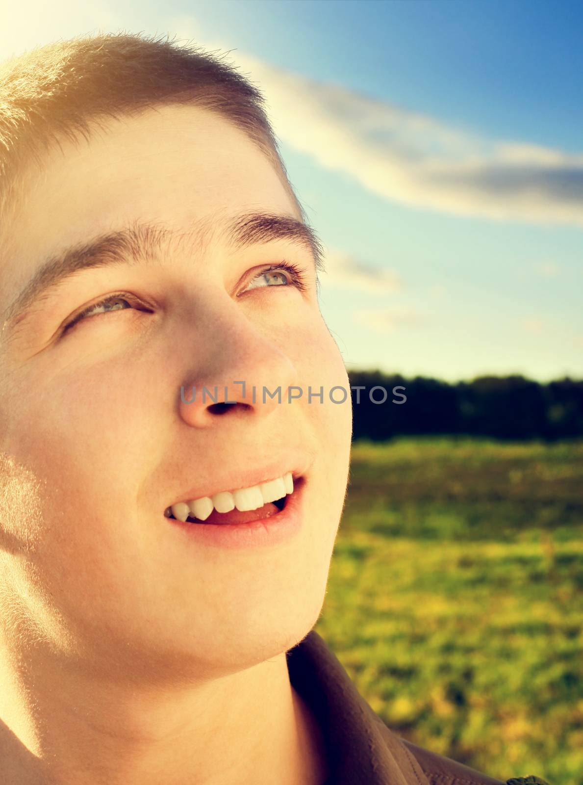 Toned photo of Happy Teenager portrait at the Field