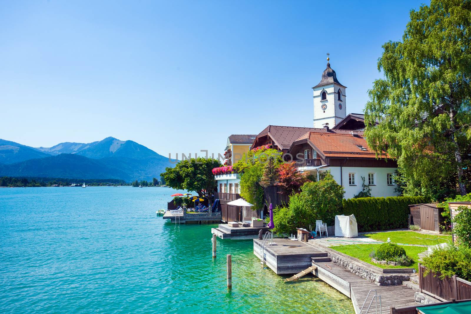 View of View of St. Wolfgang chapel and the village waterfront at Wolfgangsee lake, Austria