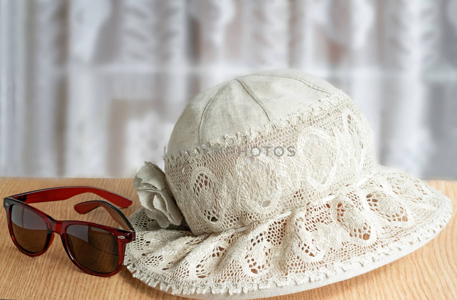 Female hat from linen fabric and lacy fabric for protection against the sun, the darkened points. These are subjects for summer holiday.