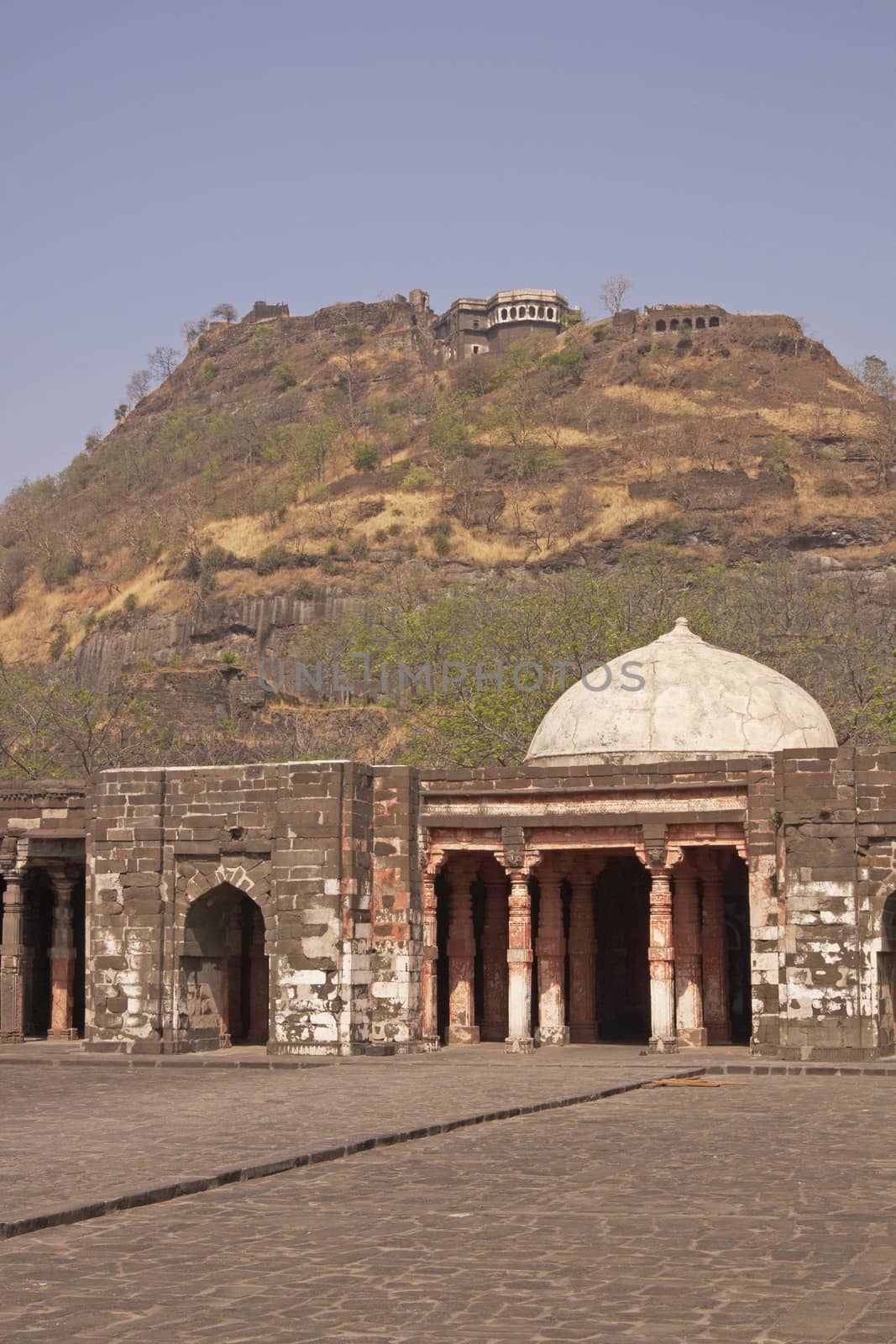 Mosque inside Daulatabad Fortress, India. Citadel of the fort on the hilltop in the distance. 14th Century AD