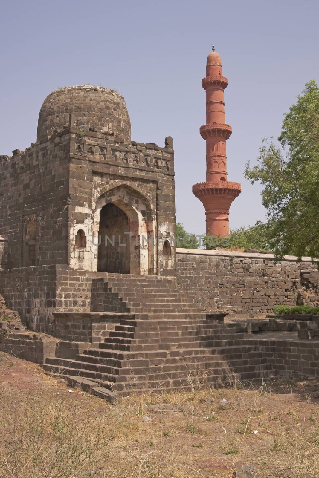 Entrance to the Mosque inside Daulatabad Fortress, India. Islamic victory tower (Chand Minar) in the background. 14th Century AD