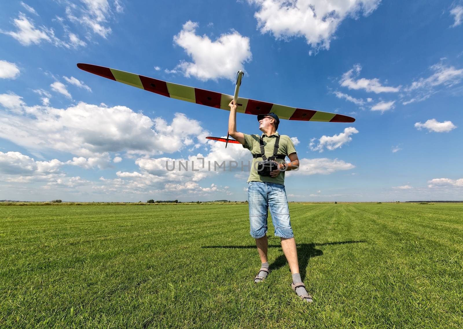 Man launches into the sky RC glider, wide-angle