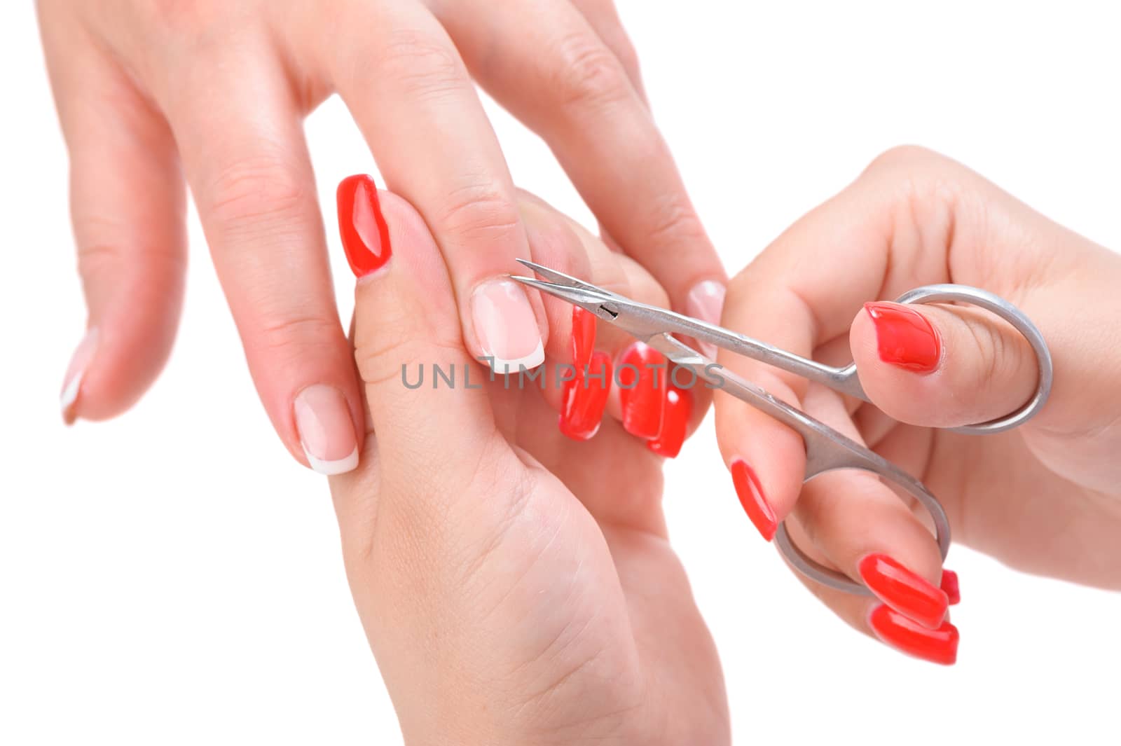 beauty salon, manicure applying, cutting the cuticle with scissors