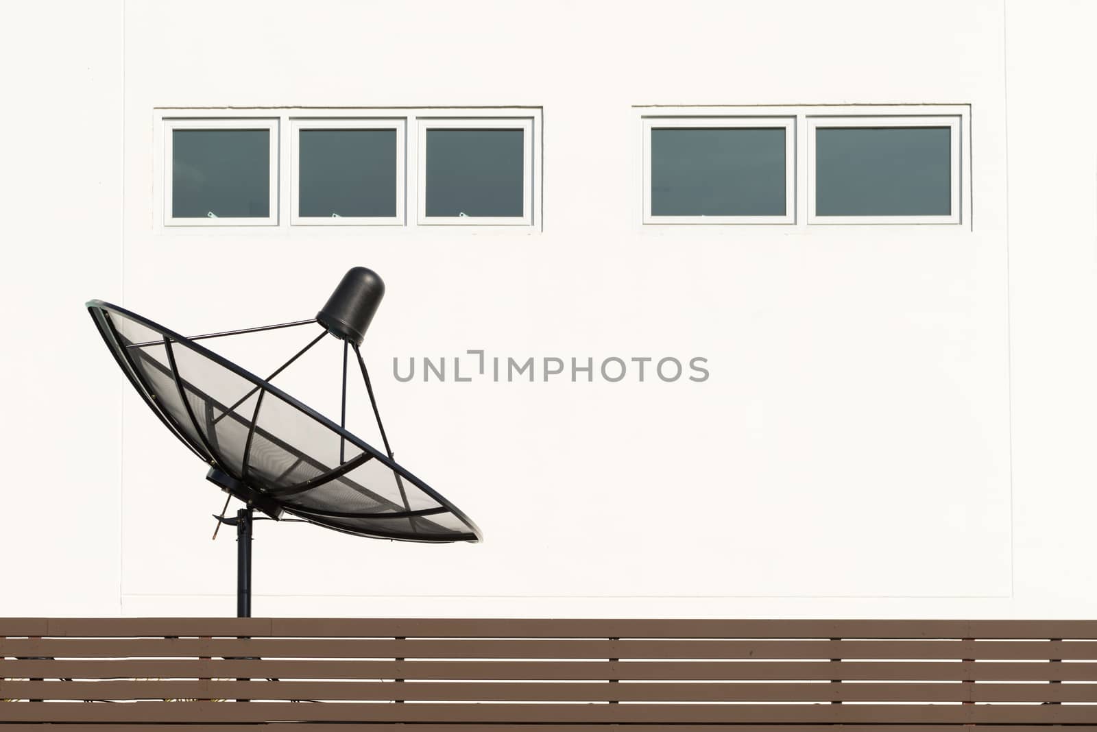 Satellite dish TV antennas beside house on the second floor
