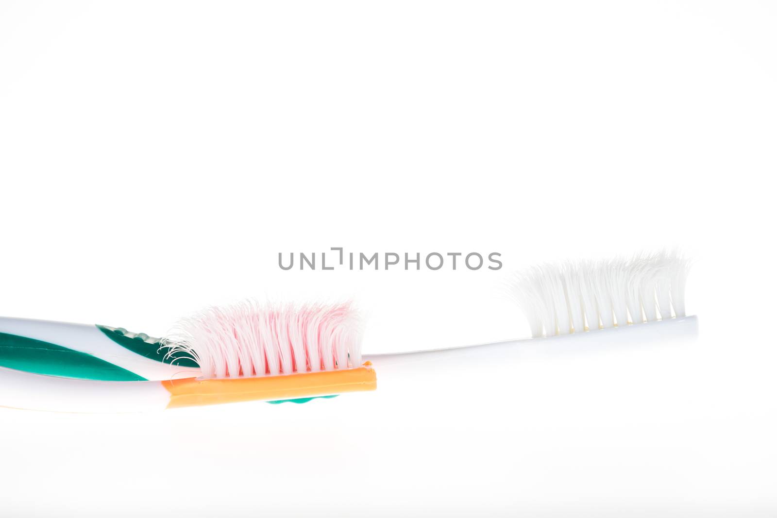 Two Color worn toothbrush on isolated white background by iamway